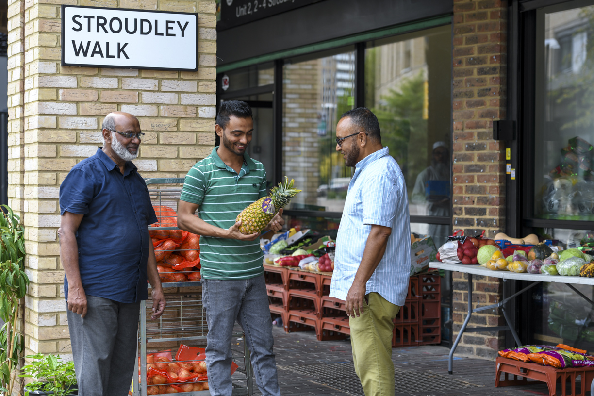 Local neighbours chatting outside the shops on Stroudley Walk