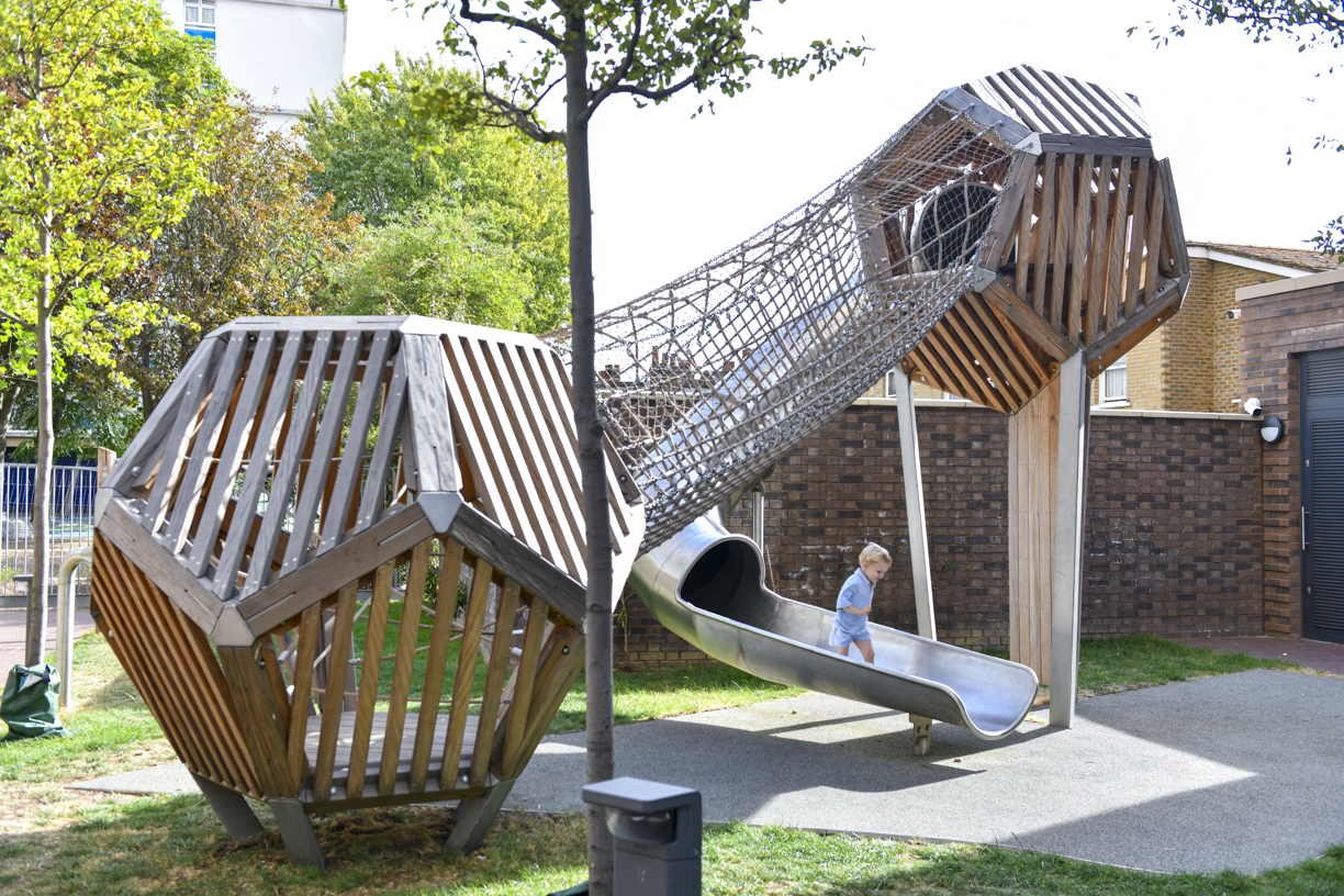 Wooden play towers and slide at Stroudley Walk