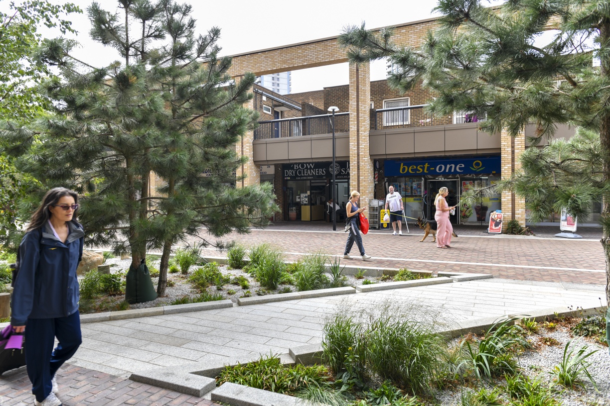 Trees and green spaces in front of the shopping parade